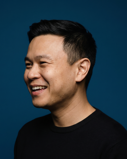 Chip smiling, against a dark blue background