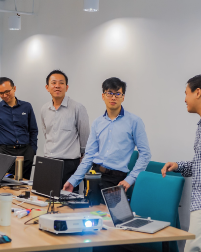 Chip with a team around their laptops during a design sprint workshop